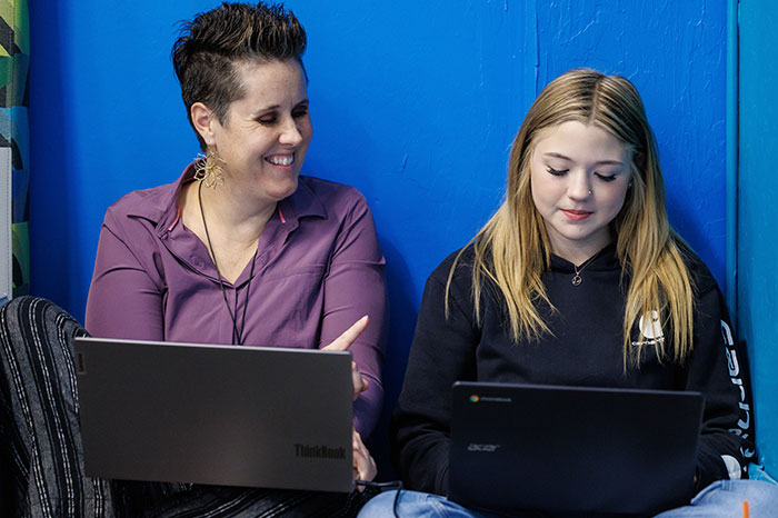 student learning alongside coach